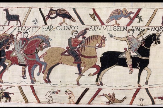 A scene from the Bayeux Tapestry depicting a naked man with an erection reaching out towards a naked woman, who is covering both her face and her pudenda with her hands. (© Bayeux Museum)