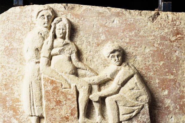An ancient Roman relief depicting scene of childbirth. An ancient Roman relief depicting scene of childbirth.