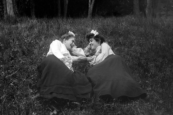 Two women share a tender moment, c1902