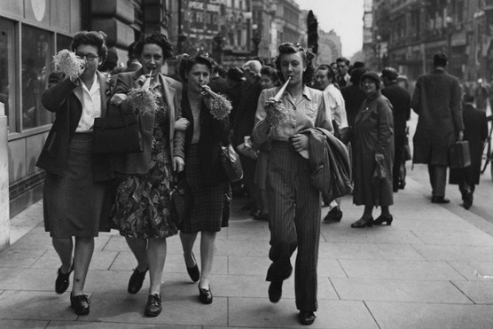 VE Day revellers blowing party trumpets